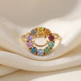Smiley Ring | Moissanite in yellow gold, laid flat on a tabletop