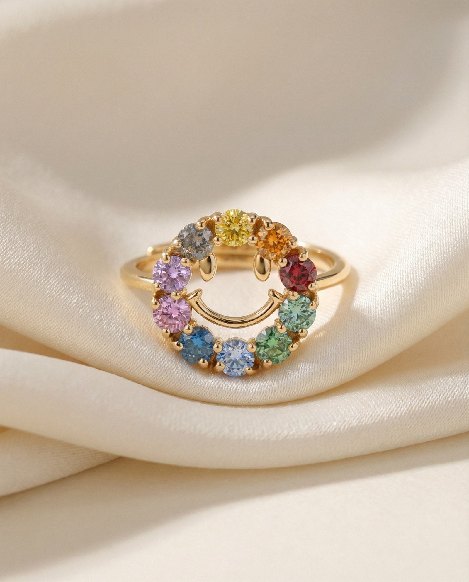 Smiley Ring | Moissanite in yellow gold, laid flat on a tabletop