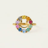 Smiley Ring | Moissanite in yellow gold, resting on a warm linen background