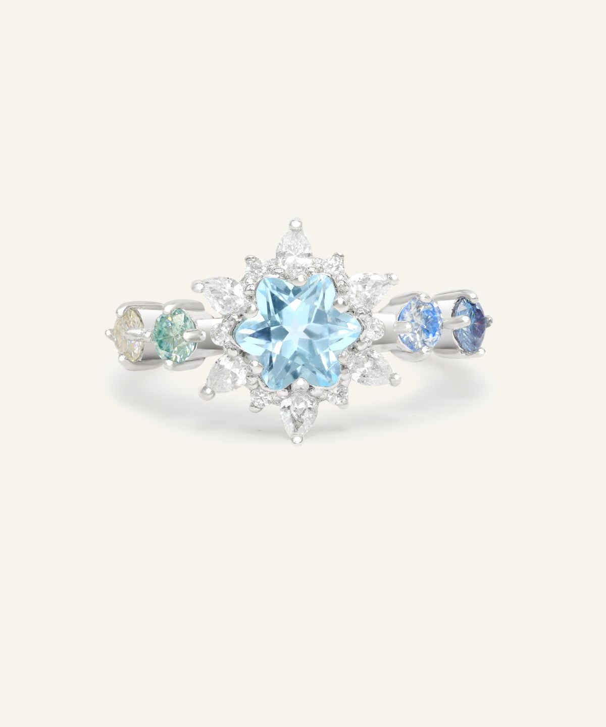 Close-up of the Starburst Snowflake Ring in silver, resting on a warm linen background