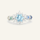 Close-up of the Starburst Snowflake Ring in silver, resting on a warm linen background