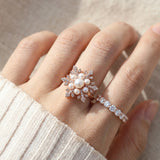 Snowflake Pearl Halo Ring in rose gold, worn on a model