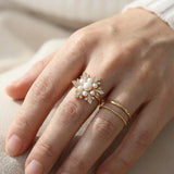 Snowflake Pearl Halo Ring in yellow gold, worn on a model