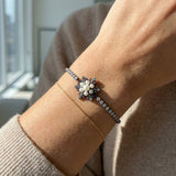 Snowflake Pearl Tennis Bracelet in black gold, worn on a model