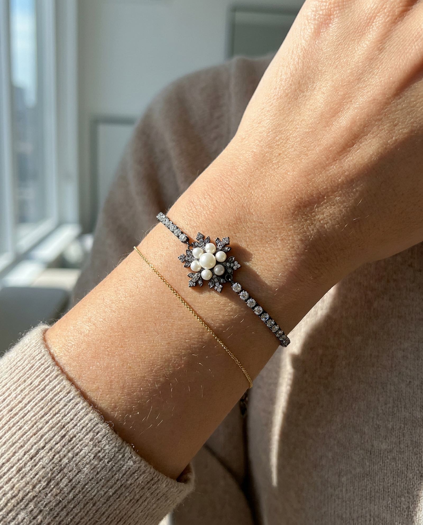 Snowflake Pearl Tennis Bracelet in black gold, worn on a model