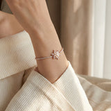 Snowflake Pearl Tennis Bracelet in rose gold, worn on a model