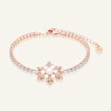 Close-up of the Snowflake Pearl Tennis Bracelet in rose gold, resting on a warm linen background