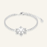 Snowflake Pearl Tennis Bracelet in silver, resting on a warm linen background