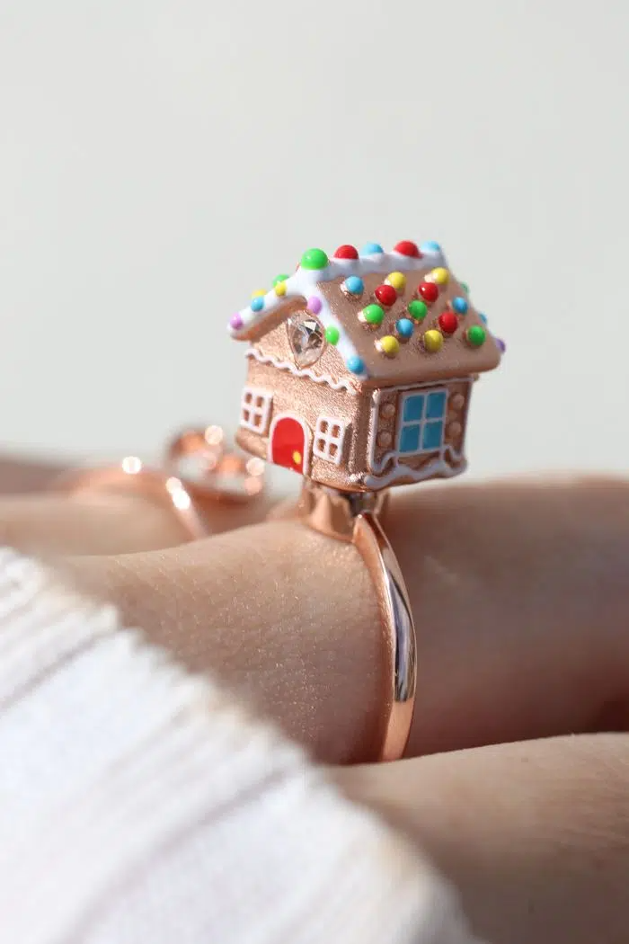 A Model wearSpinning Gingerbread House Ring Rose Gold