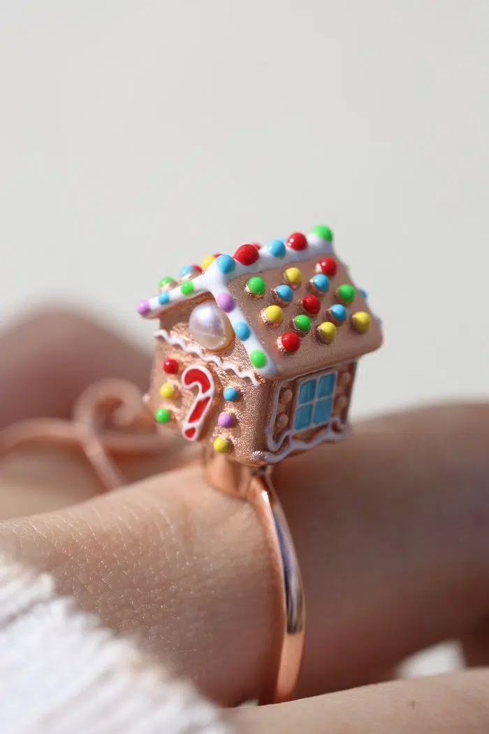 A Model wearSpinning Gingerbread House Ring Rose Gold