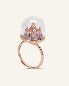 Close-up of the Spinning Magical Kingdom Ring | Natural Gemstones in rose gold, resting on a warm linen background