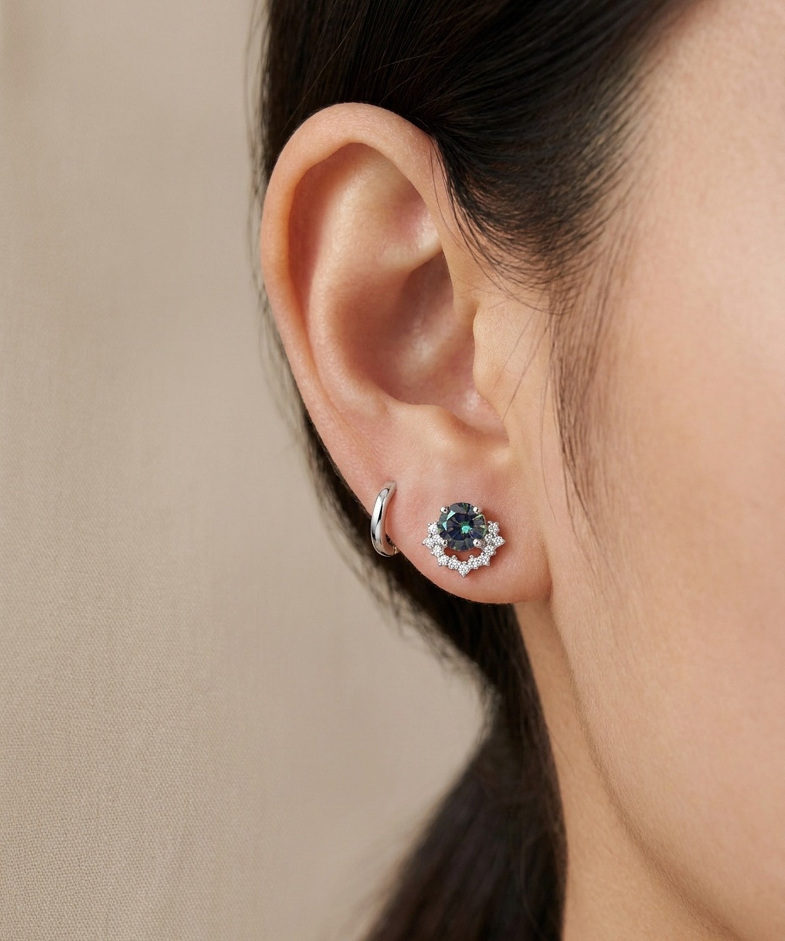 Ear stack featuring sterling silver Starlight Crown Crescent Moissanite Stud in Celestial Teal paired with a plain silver huggie hoop.