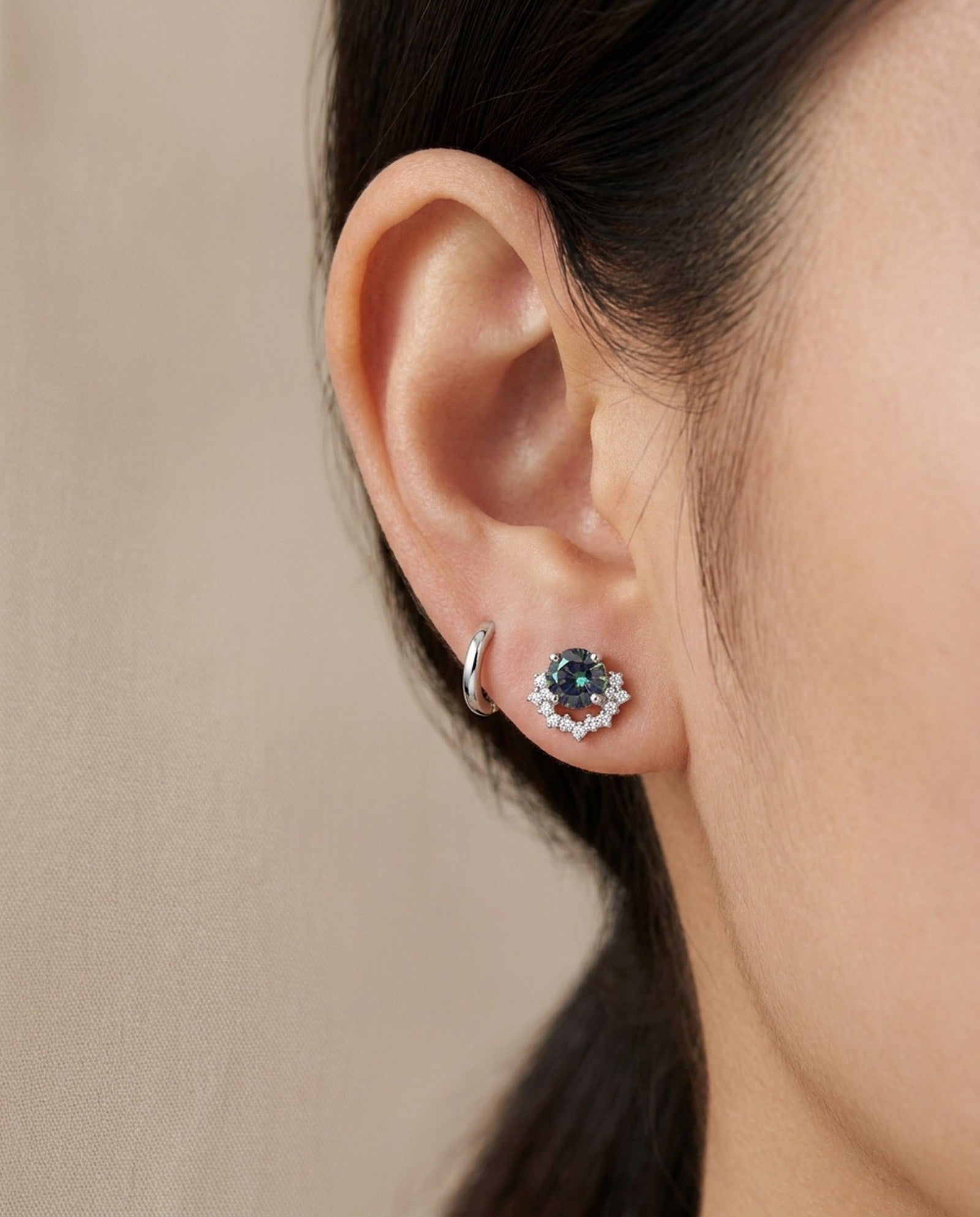 Ear stack featuring sterling silver Starlight Crown Crescent Moissanite Stud in Celestial Teal paired with a plain silver huggie hoop.