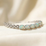 Watch Chain Opal Bracelet laid flat on a tabletop, close-up on the link detail