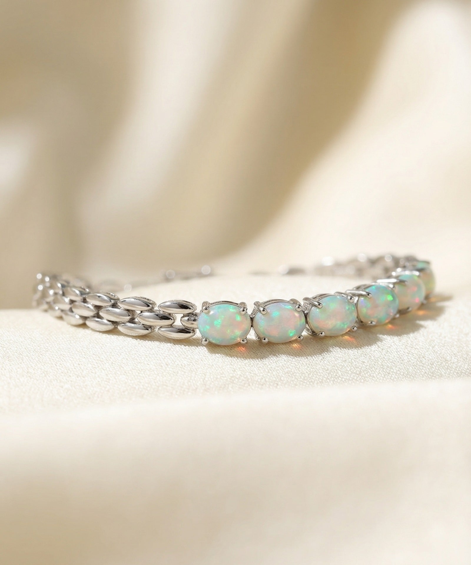 Watch Chain Opal Bracelet laid flat on a tabletop, close-up on the link detail