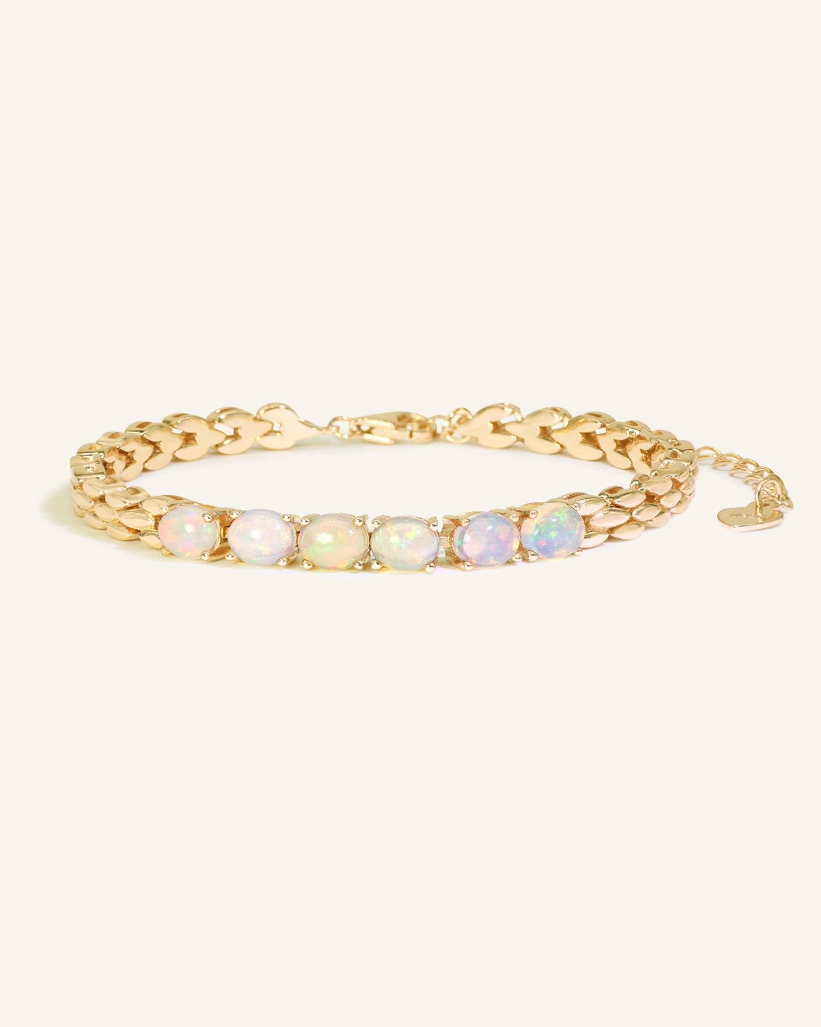 Watch Chain Opal Bracelet, resting on a warm linen background