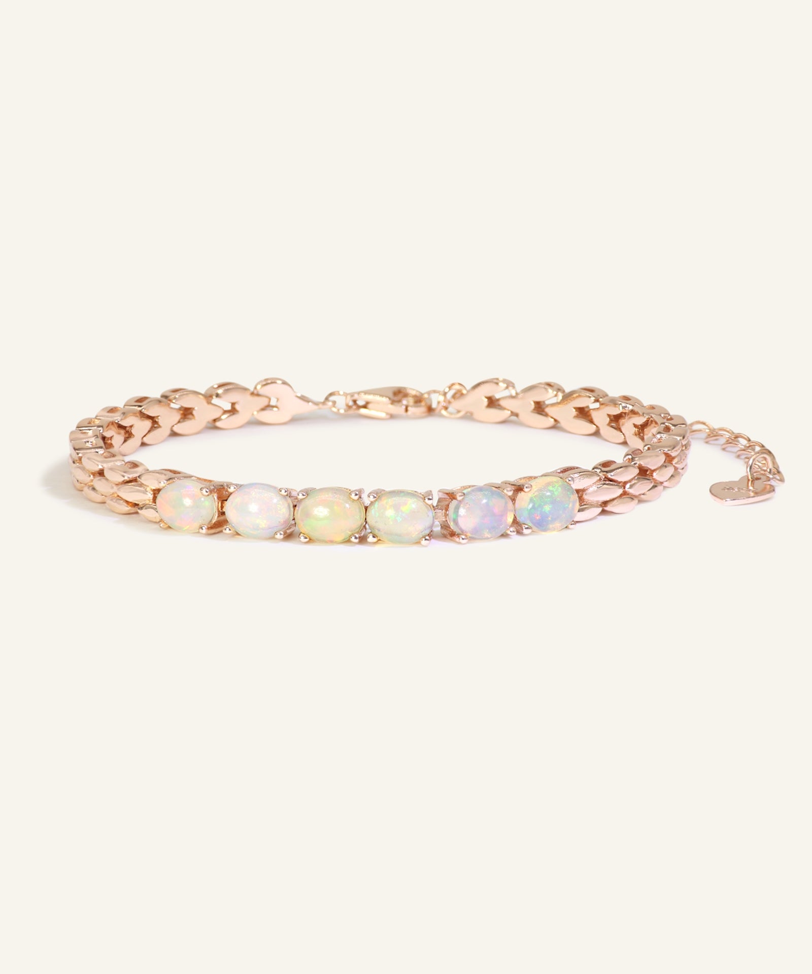 Close-up of the Watch Chain Opal Bracelet, resting on a warm linen background