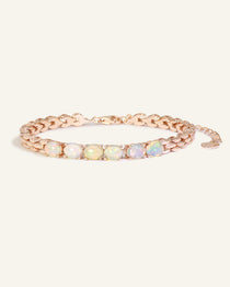 Close-up of the Watch Chain Opal Bracelet, resting on a warm linen background