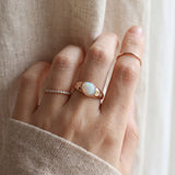 Supernova Signet Opal Ring in rose gold, worn on a model