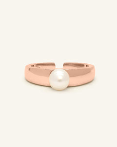 Thick Pearl Band | Elate in rose gold, resting on a warm linen background