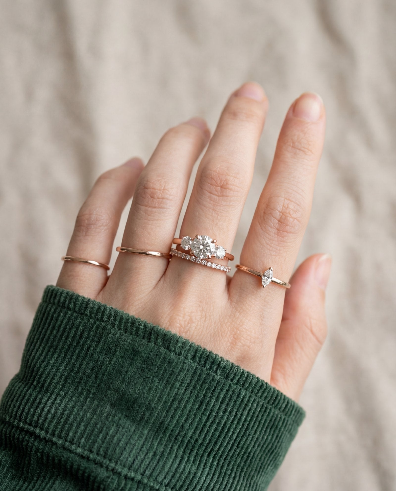 Trilogy Moissanite Ring | Elate in rose gold, worn on a model