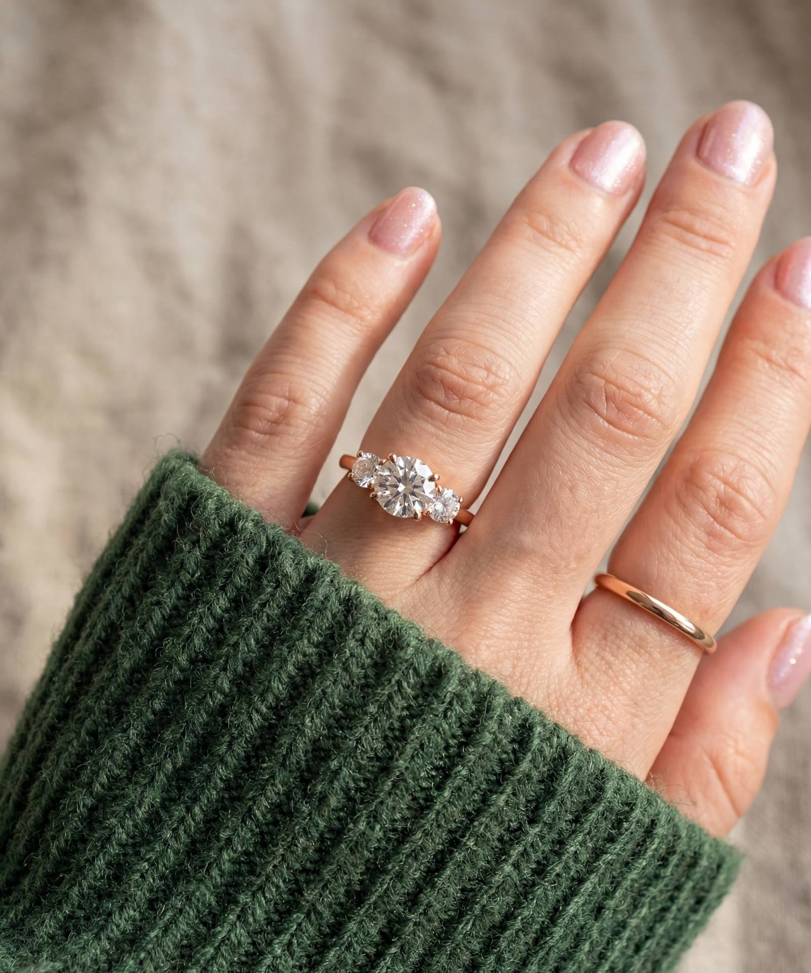 Trilogy Moissanite Ring | Elate in rose gold, worn on a model