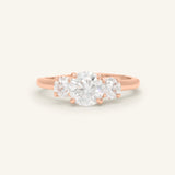 Close-up of the Trilogy Moissanite Ring | Elate in rose gold, resting on a warm linen background