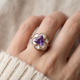 Scale shot of the Violet Grande Bloom Ring in Rose Gold worn on a finger to show the 10.5mm statement floral coverage.