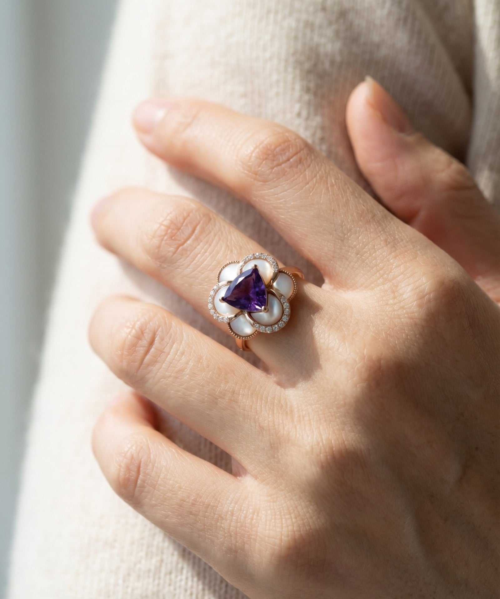 Lifestyle model shot of the Violet Grande Bloom Ring highlighting the bold floral design and slim comfort-fit band.