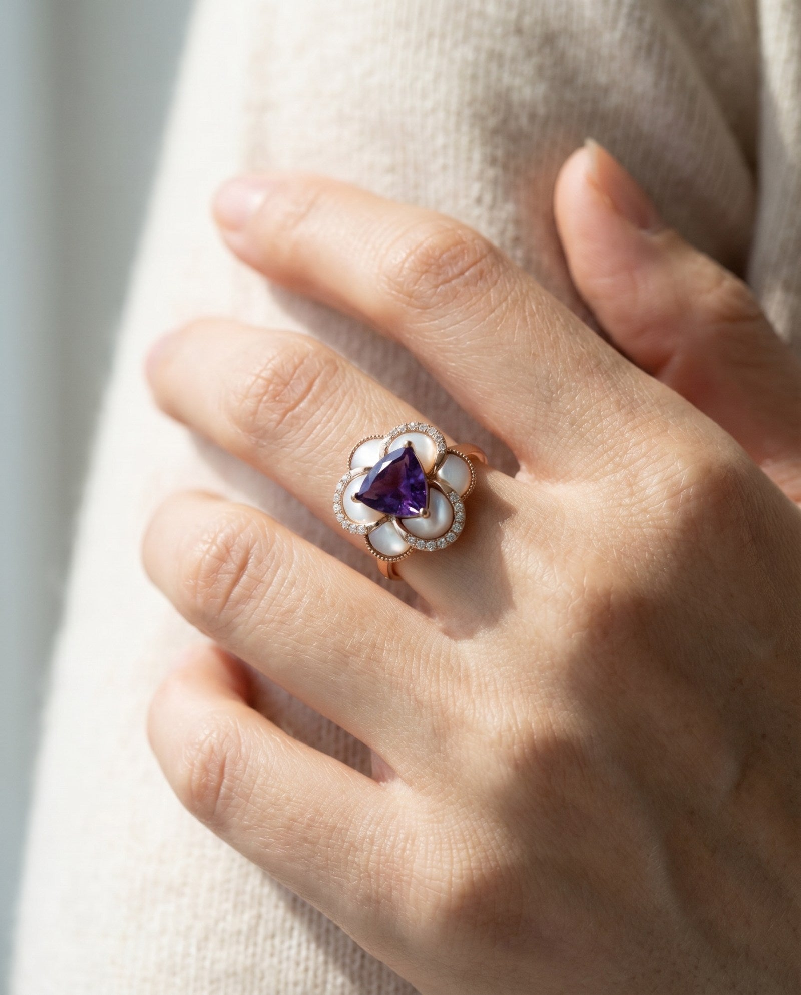 Lifestyle model shot of the Violet Grande Bloom Ring highlighting the bold floral design and slim comfort-fit band.