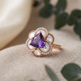Botanical flat lay of the Violet Grande Bloom Ring, highlighting the organic mother of pearl petals and natural gemstone aesthetic.