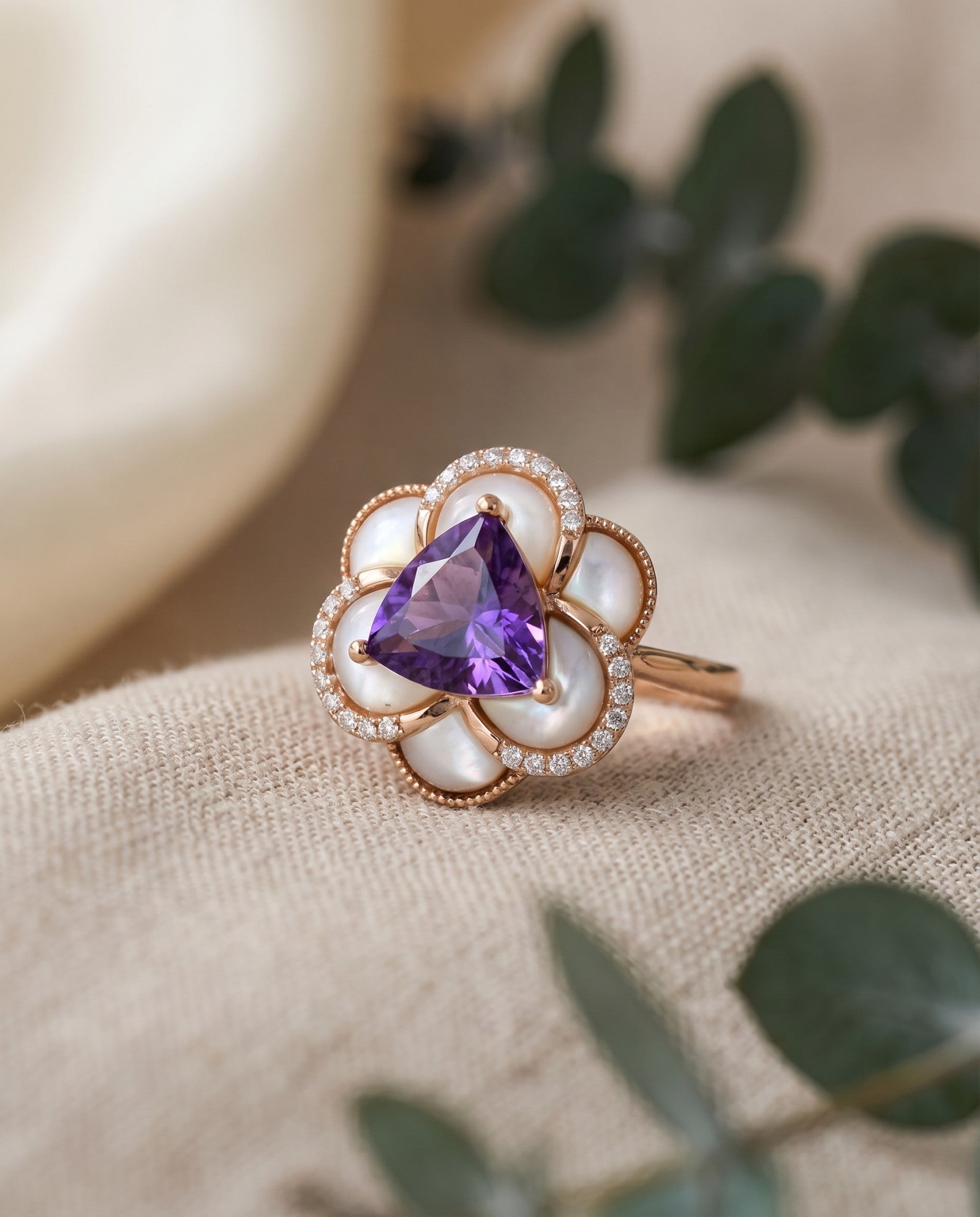 Botanical flat lay of the Violet Grande Bloom Ring, highlighting the organic mother of pearl petals and natural gemstone aesthetic.
