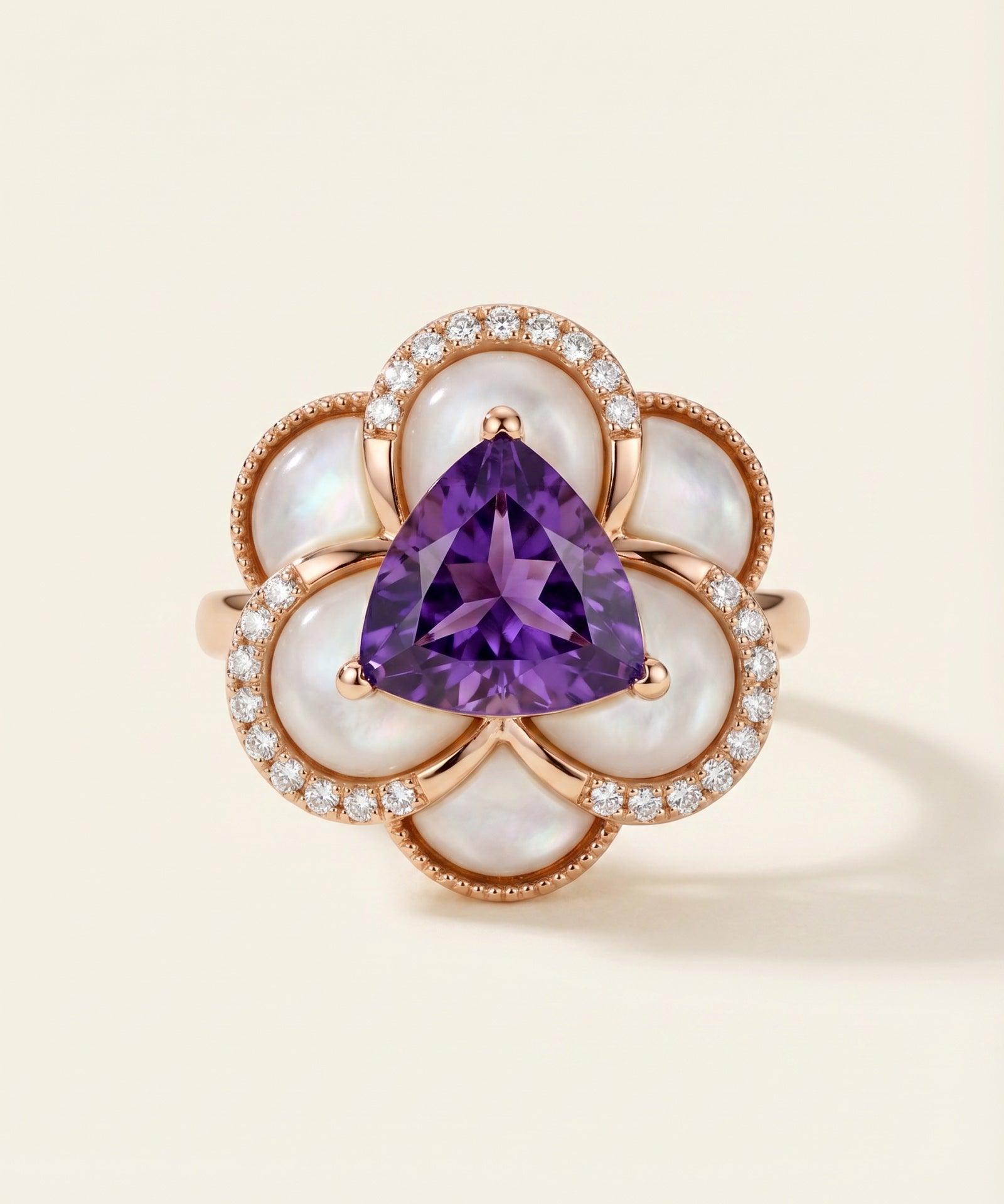 Violet Grande Bloom Ring in 18k Rose Gold showing 8mm trillion-cut amethyst and carved mother of pearl petals on a white background.