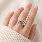 Silver Wildflower Nest rings stacked with an eternity band, showing the versatile, layered look of the pink and blue palette.