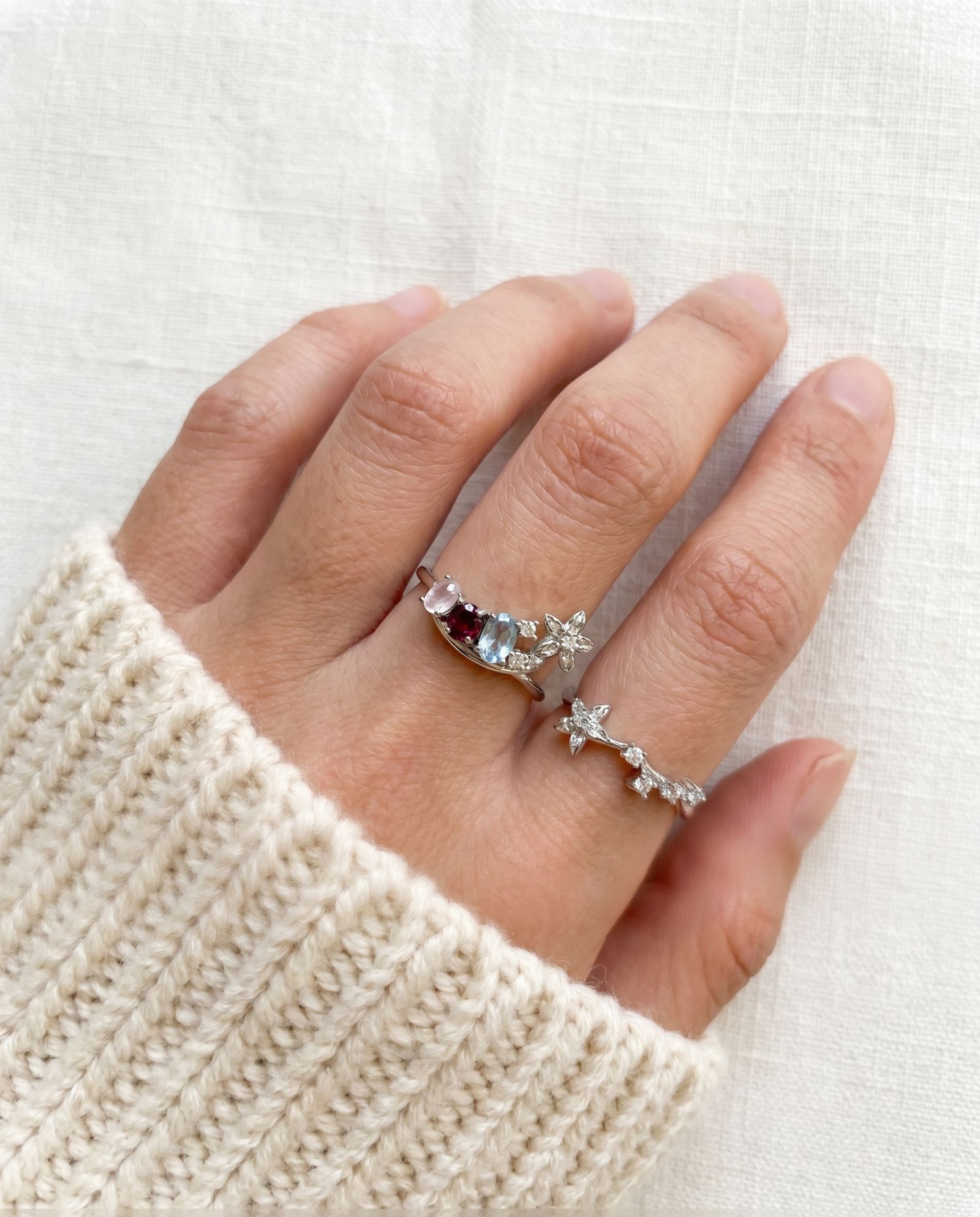 Lifestyle view of the Wildflower Nest ring set on a hand, styled as a sentimental push present for new mothers.