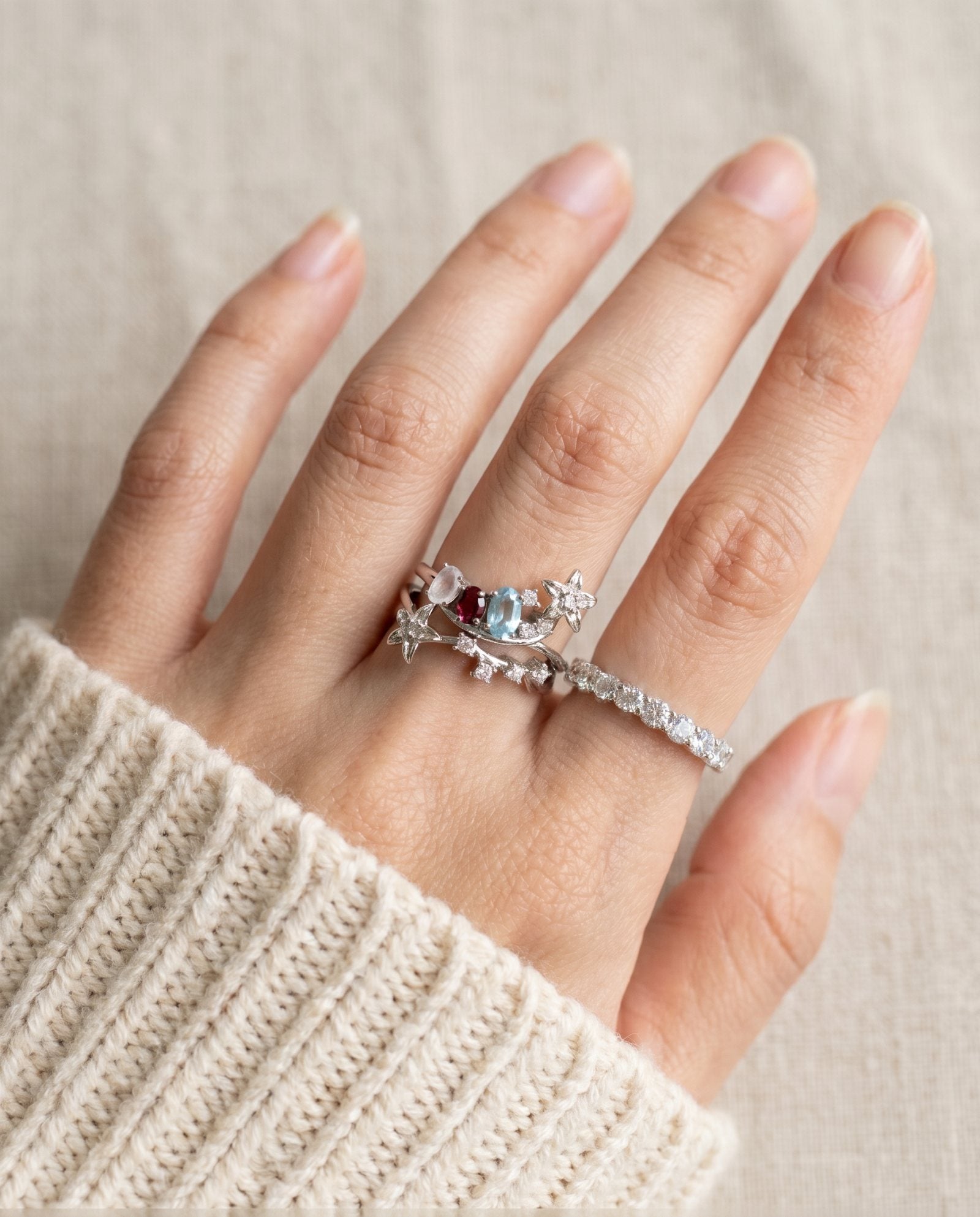 Lifestyle view of the Wildflower Nest ring set on a hand, styled as a sentimental push present for new mothers.