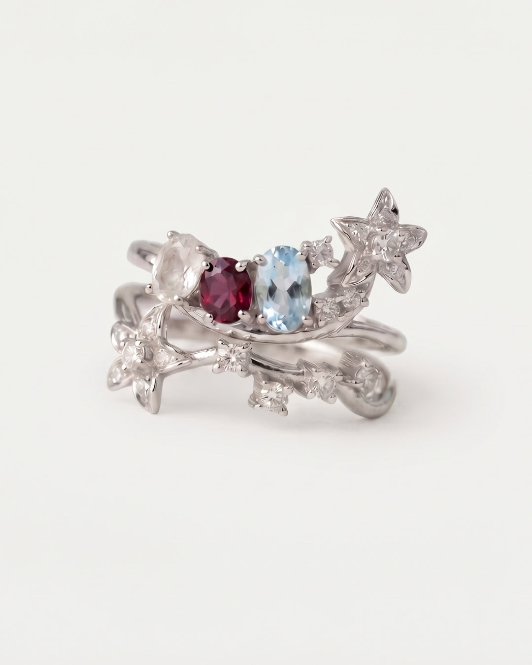 Wildflower Nest two-piece stacking ring set in silver featuring oval-cut Rose Quartz, Rhodolite, and Sky Blue Topaz gemstones.