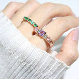 Arc de Triomphe Amethyst Ring in rose gold, angled view worn on a hand beside a green gemstone ring