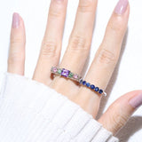 Arc de Triomphe Amethyst Ring in silver, worn on an open hand beside a blue gemstone band