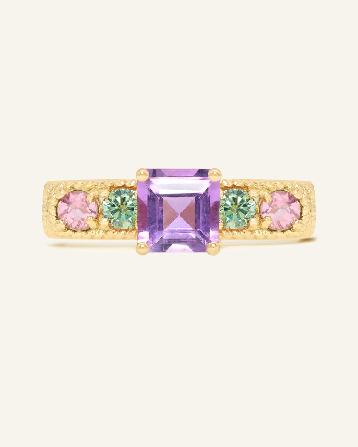 Arc de Triomphe Amethyst Ring in yellow gold, front view of the amethyst and colourful gemstone band on warm ivory