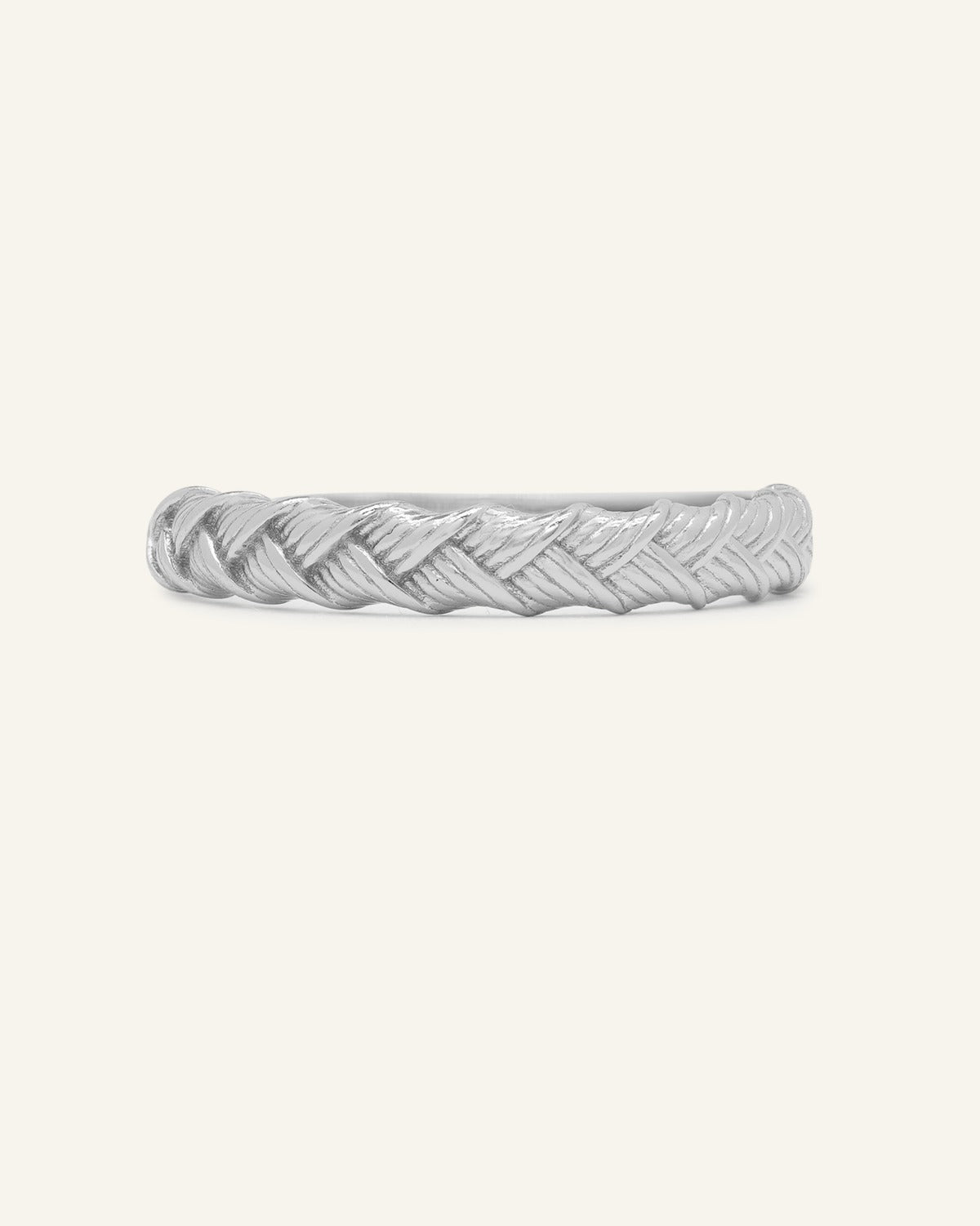 Braided Bliss Band in silver, front view of the textured braided band on warm ivory