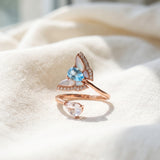 Rose gold butterfly ring with Swiss blue topaz, rose quartz and mother-of-pearl wings on ivory linen