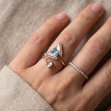 Rose gold butterfly ring with Swiss blue topaz and rose quartz worn alongside other rings