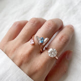 Rose gold butterfly ring with Swiss blue topaz and rose quartz worn alongside other rings