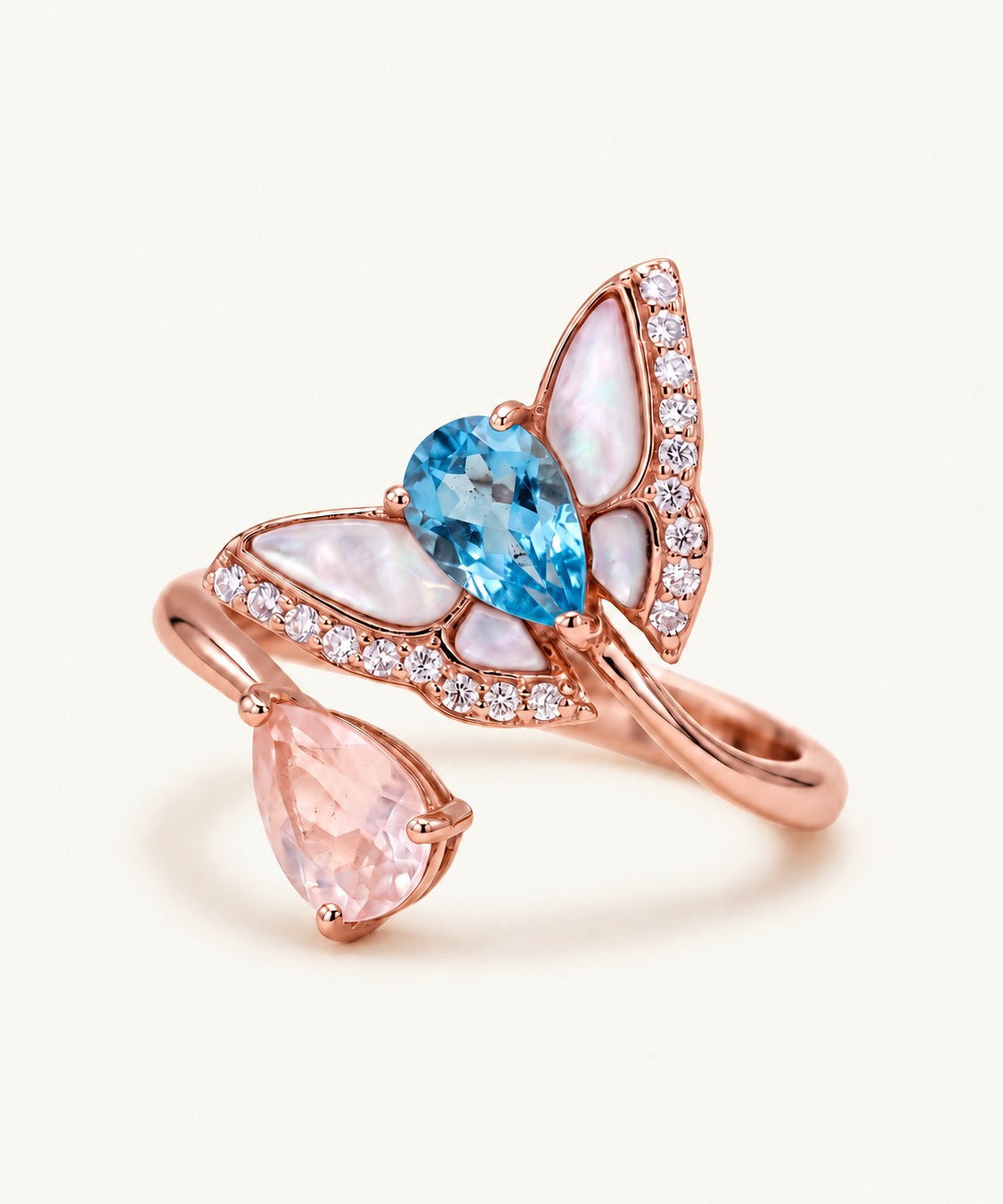 Rose gold butterfly toi et moi ring with pear-cut Swiss blue topaz and rose quartz, mother-of-pearl wings and CZ accents