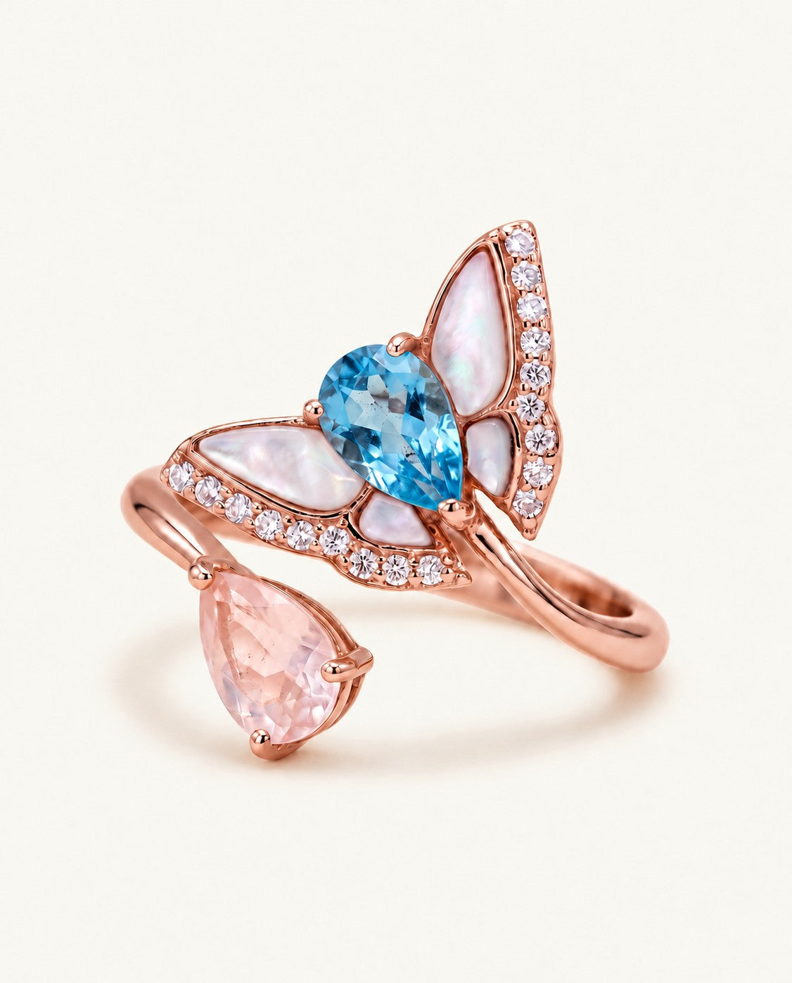 Rose gold butterfly toi et moi ring with pear-cut Swiss blue topaz and rose quartz, mother-of-pearl wings and CZ accents