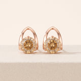 Champagne moissanite stud earrings in rose gold showing the open pointed setting