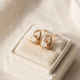 Champagne moissanite stud earrings in yellow gold displayed on a jewellery box