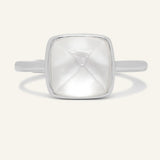 Clear Quartz and Mother of Pearl Sugarloaf Ring in silver, front view of the sugarloaf bezel setting on warm ivory