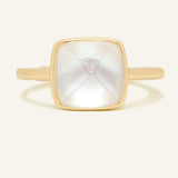 Clear Quartz and Mother of Pearl Sugarloaf Ring in yellow gold, front view of the sugarloaf bezel setting on warm ivory